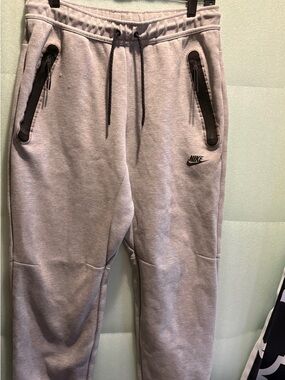 Nike Tech Light Gray Sweatpants with Black Zip Pickets and Tapered Details